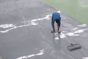 Man rolling epoxy on a floor