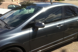 A newer Honda Civic with tinted windows.