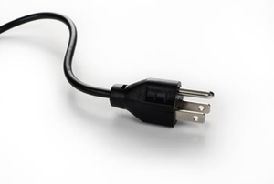 A three-pronged plug to an electronic device or appliance.
