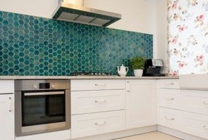 an aqua marine backsplash in a clean kitchen