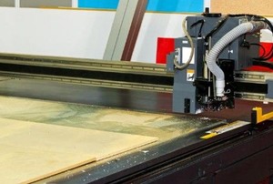a woodworking router table against a tile background