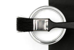 Paint brush on top of an open can of white paint
