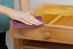 sanding a wooden drawer