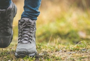 booted feet walking on grass