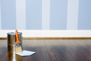 A wall painted in two-tone blue stripes.