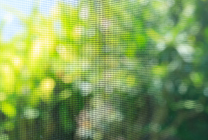 screen material with bushes in the background