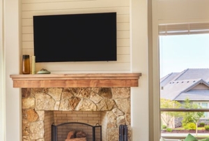 Plasma TV over fireplace.