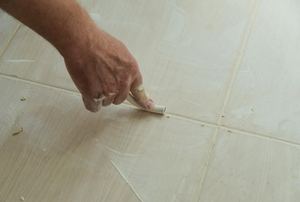 Applying grout in between tiles