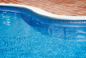 The edge of a clean, in ground pool.