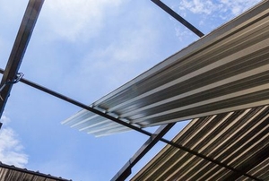 corrugated tin roof getting installed