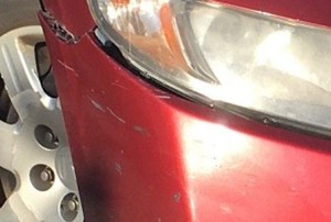 scratched bumper on a red car