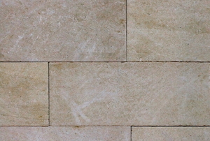 A back drop of natural stone tile.