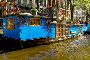a blue houseboat on the water