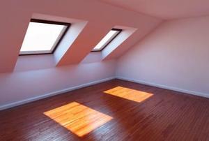 Attic windows casting squares of light on a finished floor.