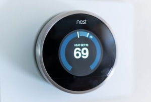 Nest thermostat on wall set to 69 degrees
