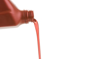 liquid pouring out of a red bottle
