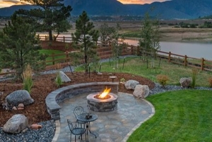 landscaped yard with fire pit area