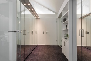 walkway with mirrored closet doors