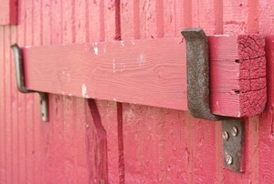 close-up of reddish pink wooden ledge-and-brace door