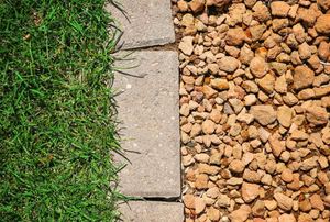 grass and rock separated by pavers