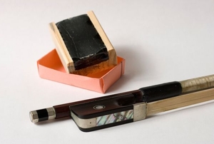 violin rosin next to bow
