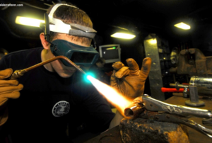 a man welding a metal part