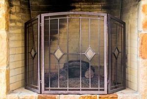 limestone fireplace with metal screen