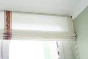 White Roman shade on a window
