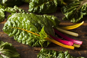 Swiss chard leaves on a wooden table.