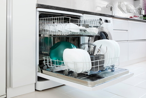 An open dishwasher with the loaded racks pulled out.