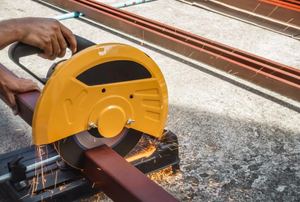 A chop saw cutting metal.