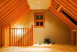 Looking at the staircase to and window looking out of a newly-finished attic.