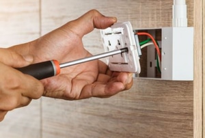 hands installing outlet