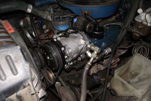 AC compressor alongside other engine parts