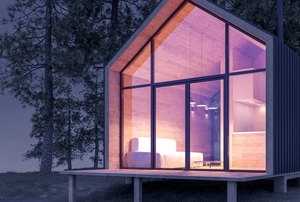 beautiful tiny house on the water at night with a glass front wall