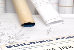 A building permit against blueprints.