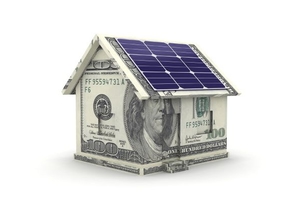 A house made of money with solar panels.