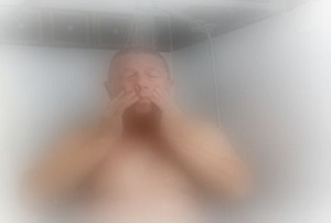 A big man in a steamed up shower.