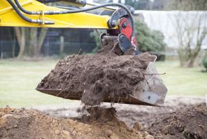 A tractor shoveling dirt.