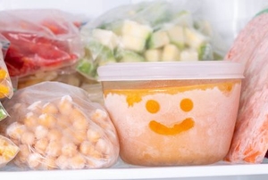 vegetables frozen in freezer with a smiley face drawn on one container