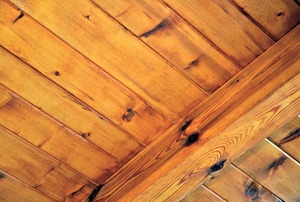 A wooden beam and planks running perpendicularly to one other.