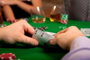hand of cards at a poker table