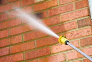 power washing a brick wall