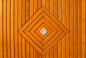 A diamond-shaped pattern in a wood-plank ceiling.