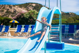 A child going down a pool slide.