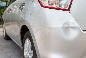 the back of a car with a small dent