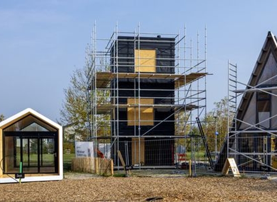 three different tiny homes under construction