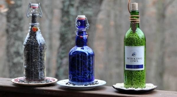 A trio of bird feeders made from wine bottles.