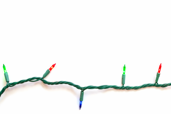 A strand of colored Christmas lights against a white background. 