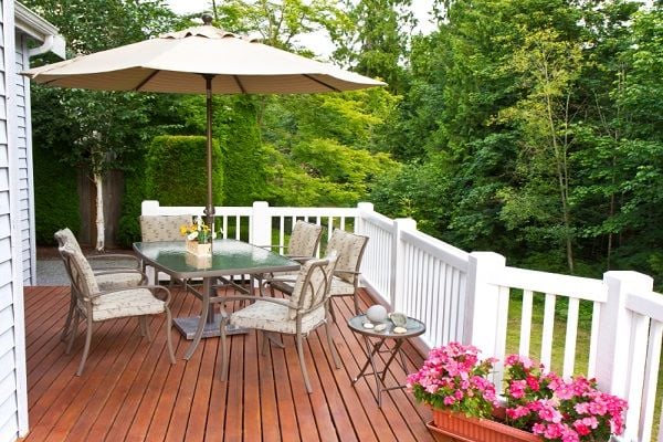 deck with dining set and umbrella